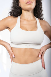 Girl wearing a high Impact Sports Bra in beige